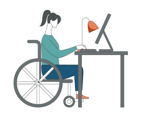 A woman in a wheelchair sitting at a desk and using a computer.