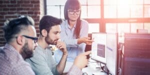 A team of developers working collaboratively on ADA compliance to make a website fully accessible.