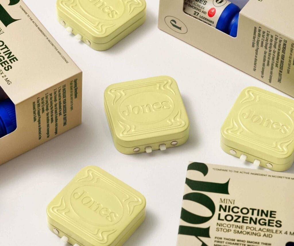 Several pale yellow Jones nicotine lozenge cases and their cardboard packaging are arranged on a light surface.