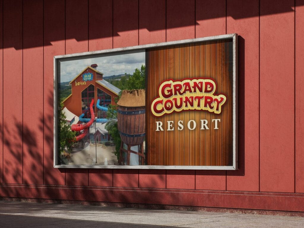 A billboard on a red wall displays the Grand Country Resort logo alongside an image of a water park attraction.