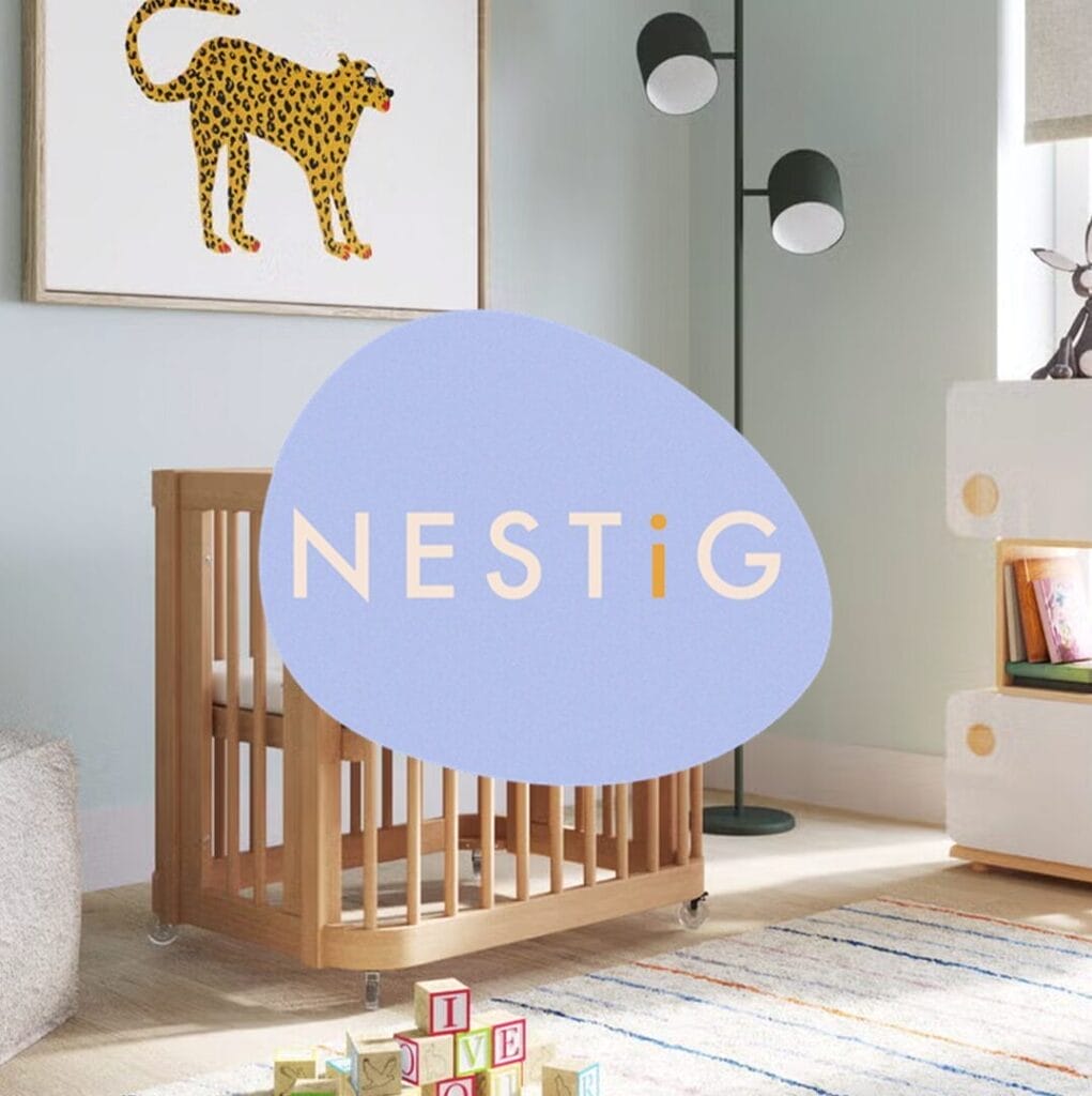 A modern nursery with a wooden crib, a cheetah art print, a floor lamp, and children's blocks, with the "NESTiG" logo overlaid in the center.